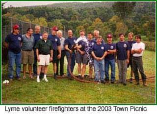 Fire department staff standing together in a field 